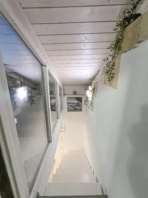 a hallway with stairs with plants on the walls at Charming Old Tannery House with Spacious Veranda and Stunning Sea View! in Chania Town