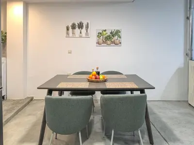 a table with chairs and a bowl of fruit on it at Charming Old Tannery House with Spacious Veranda and Stunning Sea View! in Chania Town