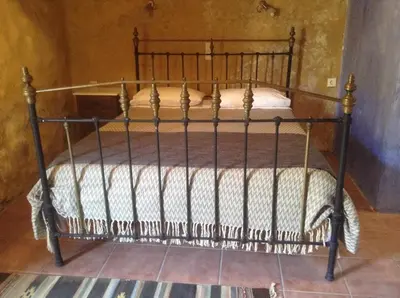 a bed with a metal bed frame in a room at Villa Alexandrou in Vamos