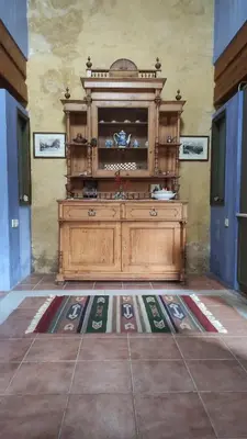 a large wooden cabinet in a room with a tile floor at Villa Alexandrou in Vamos