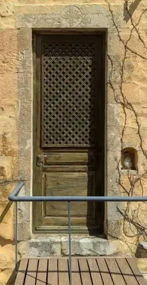 a wooden door on the side of a building at Villa Alexandrou in Vamos
