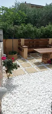 a stone patio with a bench and a picnic table at Antony Home in Kounoupidhianá