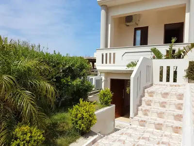 a white house with a staircase in front of it at Emily's House in Kissamos