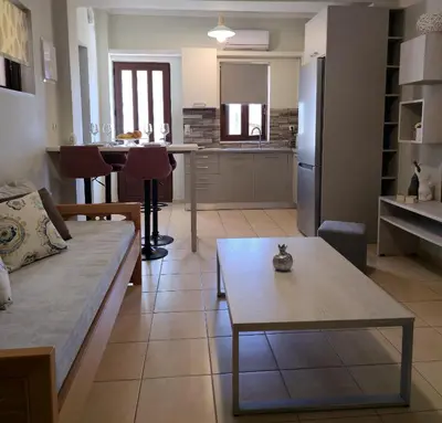 a living room with a couch and a table at Emily's House in Kissamos