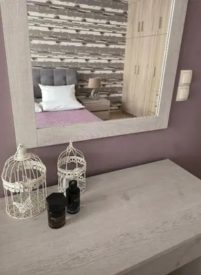 a bedroom with a bed and a large mirror at Emily's House in Kissamos