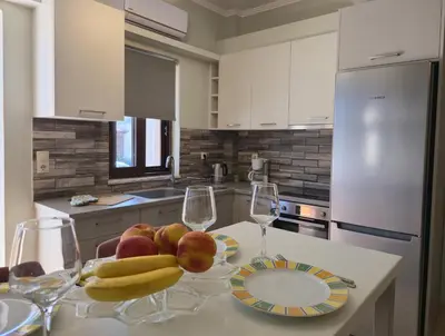 a kitchen with a table with wine glasses and fruit on it at Emily's House in Kissamos