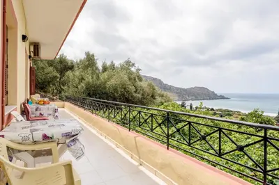 a balcony with a table and a view of the ocean at Antonis Studio in Sfinárion