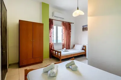 a small room with two beds and a bedroom at Antonis Studio in Sfinárion