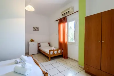 a small bedroom with a bed and a window at Antonis Studio in Sfinárion