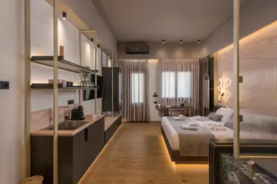 a bedroom with a bed and a sink in a room at Agave Suites in Chania Town