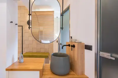 a bathroom with a large bowl sink and a mirror at Agave Suites in Chania Town