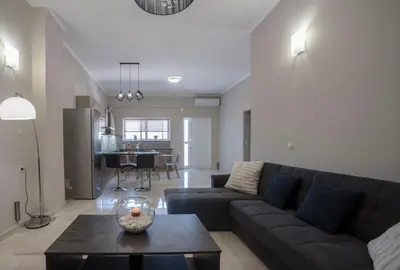 a living room with a couch and a table at BO Home in Souda