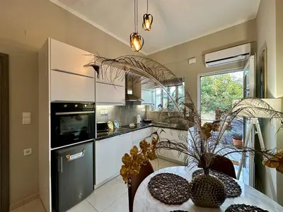 a kitchen with a table with a potted plant at BO Home in Souda