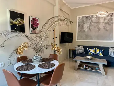 a living room with a table and a couch at BO Home in Souda
