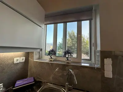 a kitchen with a sink and a window at BO Home in Souda