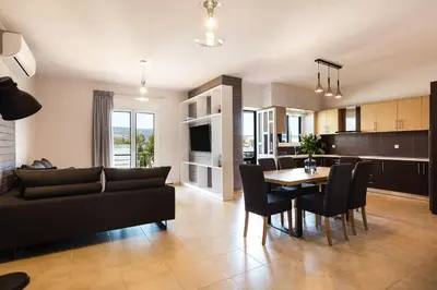 a living room with a couch and a table at Ethereal Apartments Chania in Souda