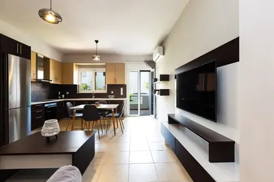 a living room with a kitchen and a dining room at Ethereal Apartments Chania in Souda