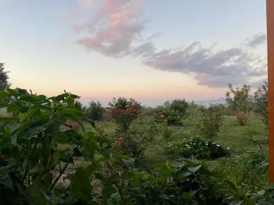 a view from the garden at sunset at Chrissi's house with garden and sea view Zerviana in Kissamos