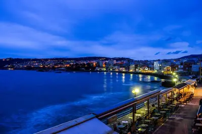 a view of a body of water at night at East Seafront Suite in Chania Town