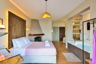 a hotel room with a bed and a bath tub at East Seafront Suite in Chania Town