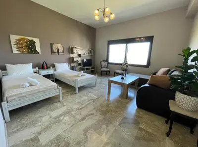 a living room with a bed and a couch at Kyparissos Apartment I in Kissamos