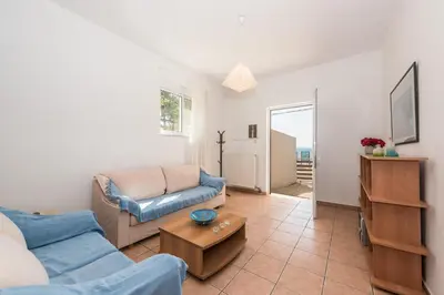 a living room with a couch and a table at Villa SteMa in Xirokámbion
