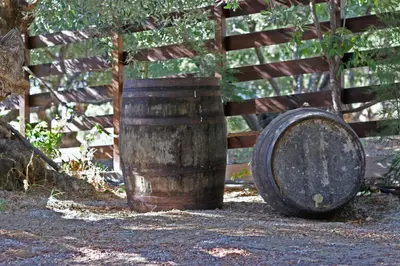 a wooden barrel sitting next to a wooden fence at Villa SteMa in Xirokámbion