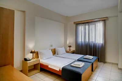 a hotel room with a bed and a window at Veronica Hotel in Kato Daratso