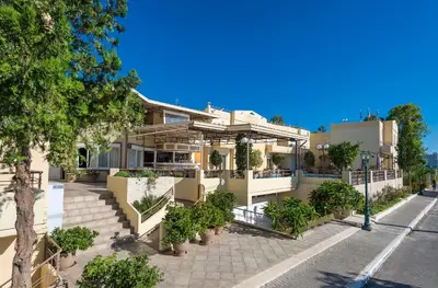 a building with trees and plants in front of it at Veronica Hotel in Kato Daratso