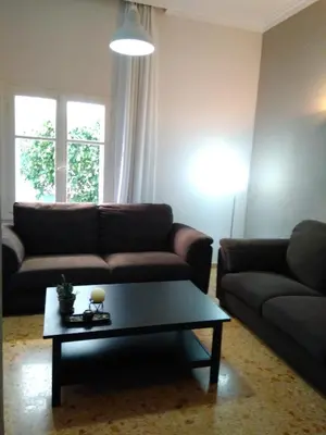 a living room with a couch and a coffee table at Zacharoula's Home in Chania Town