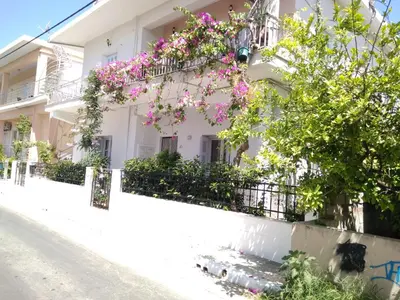 a white building with flowers on the side of it at Zacharoula's Home in Chania Town
