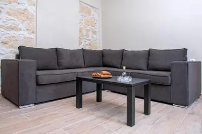 a black couch and a coffee table in a room at Elegant Apartment in Chania Town