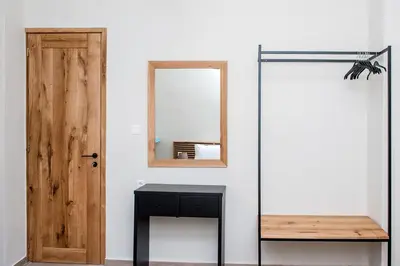 a room with a mirror and a black table at Elegant Apartment in Chania Town