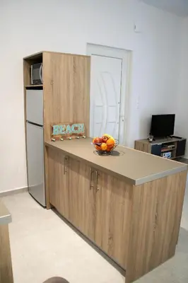 a kitchen with a counter with a bowl of fruit on it at Orama Suites II in Kato Daratso