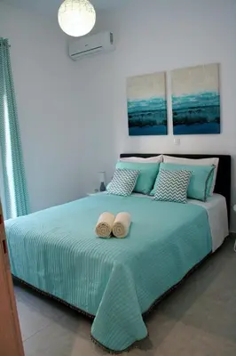 a bedroom with a bed with two hats on it at Orama Suites II in Kato Daratso