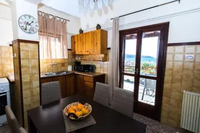 a kitchen with a table with a bowl of fruit on it at Stalos View in Stalos