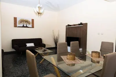 a living room with a glass table and a fireplace at Stalos View in Stalos