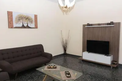 a living room with a couch and a television at Stalos View in Stalos