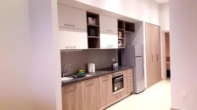 a kitchen with a sink and a refrigerator at Casa Bella Deluxe Apartments in Palaiochóra