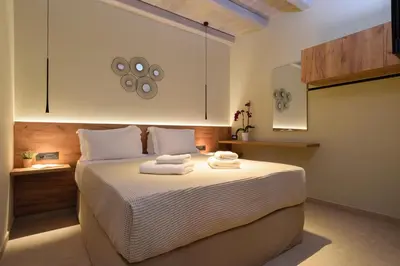 a bedroom with a bed with towels on it at Effrosini Traditional Home in Nopíyia
