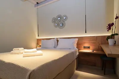 a bedroom with a bed with two towels on it at Effrosini Traditional Home in Nopíyia