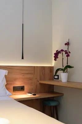 a bedroom with a bed and a desk with a potted plant at Effrosini Traditional Home in Nopíyia