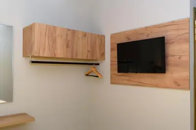 a flat screen tv hanging on a wall at Effrosini Traditional Home in Nopíyia