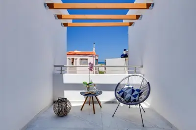 a balcony with a chair and a table at Ikia Aretousa in Kato Daratso