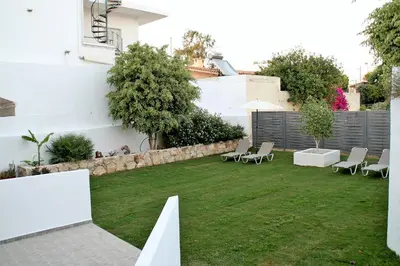 a small backyard with chairs and a lawn at Orama Suites I in Kato Daratso