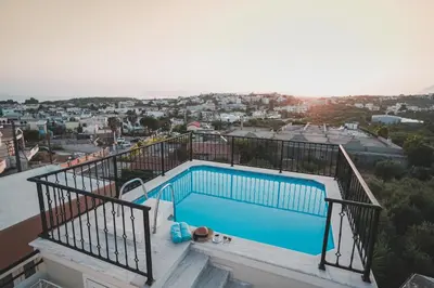 a swimming pool on the balcony of a house at Zeus Village Resort - Adults Only in Kato Daratso