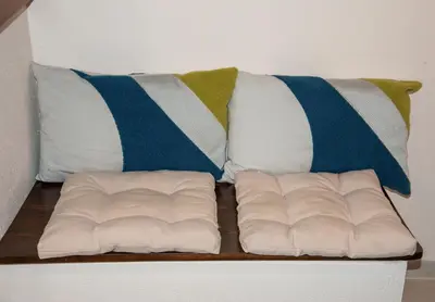 a white couch with pillows on top of it at Elisavet's House in Plataniás