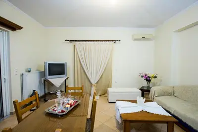 a living room with a table and a couch at Joanna 's Loft in Kissamos