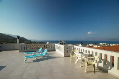 a patio with chairs and a table on a balcony at Joanna 's Loft in Kissamos