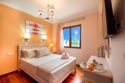 a small bedroom with a bed and a window at Casa Leone Suites in Stalos